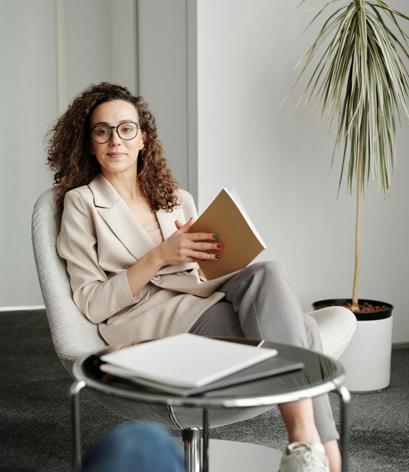 A woman confidently sitting in a chair